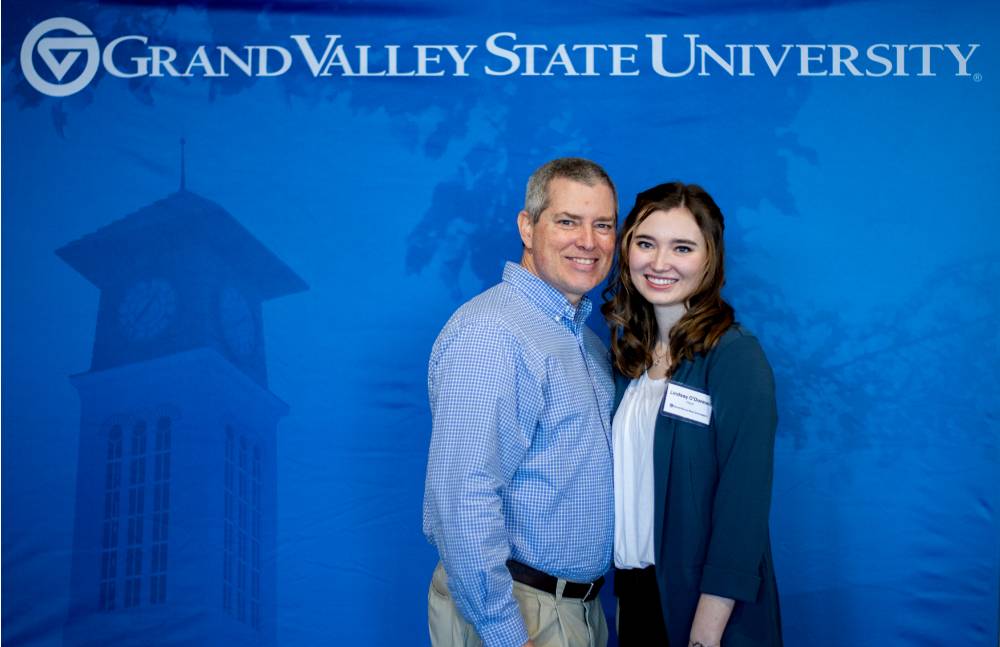 student taking picture with dad in photo